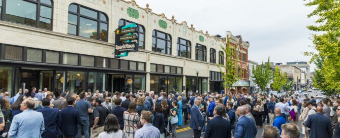 People standing on Madison Avenue in front of SparkHaus at grand opening