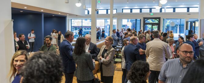 People stand inside SparkHaus at the grand opening ceremony