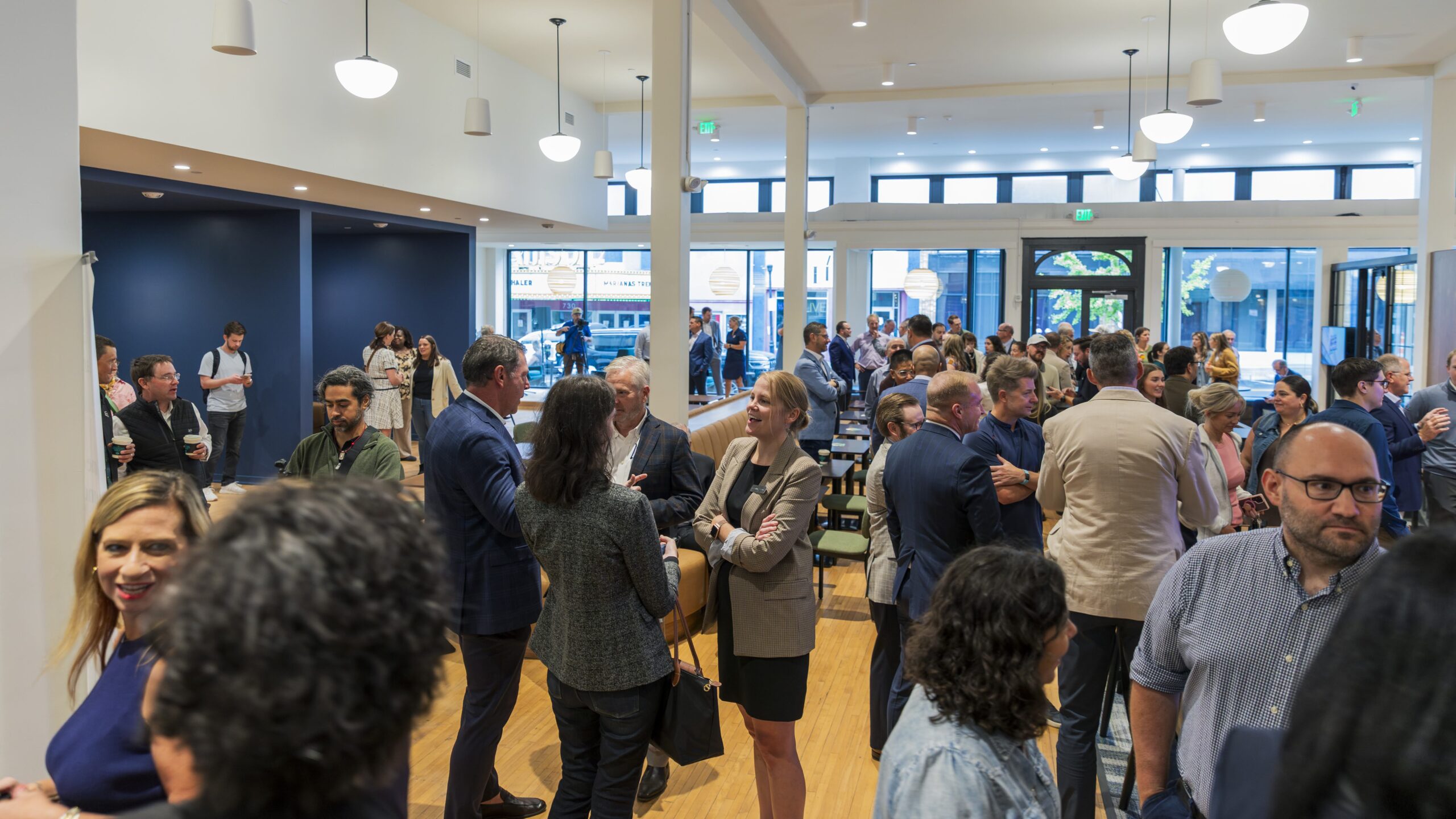 People stand inside SparkHaus at the grand opening ceremony